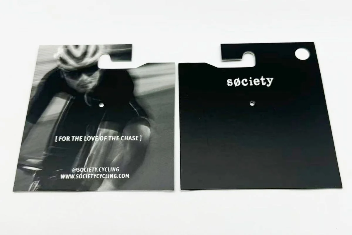Printed hanging cards with a shaped cutout and a punched hole.