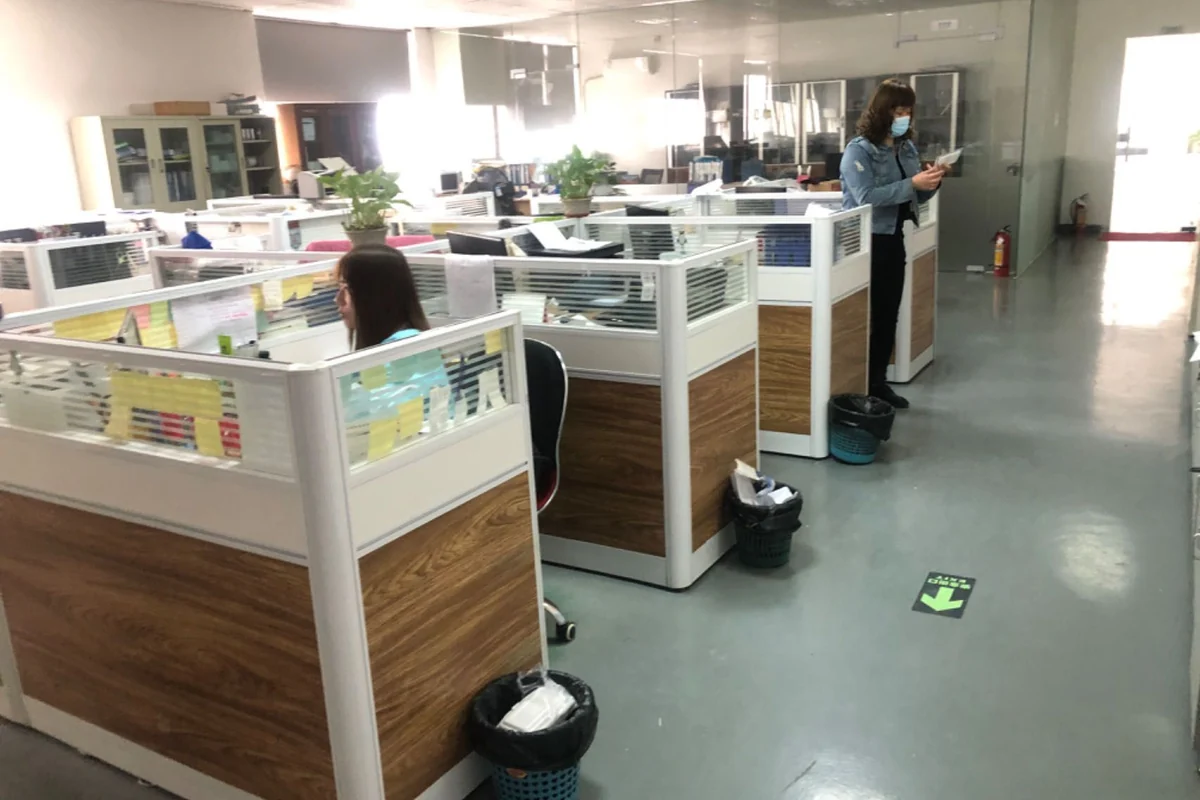 Rows of workstations inside the factory.