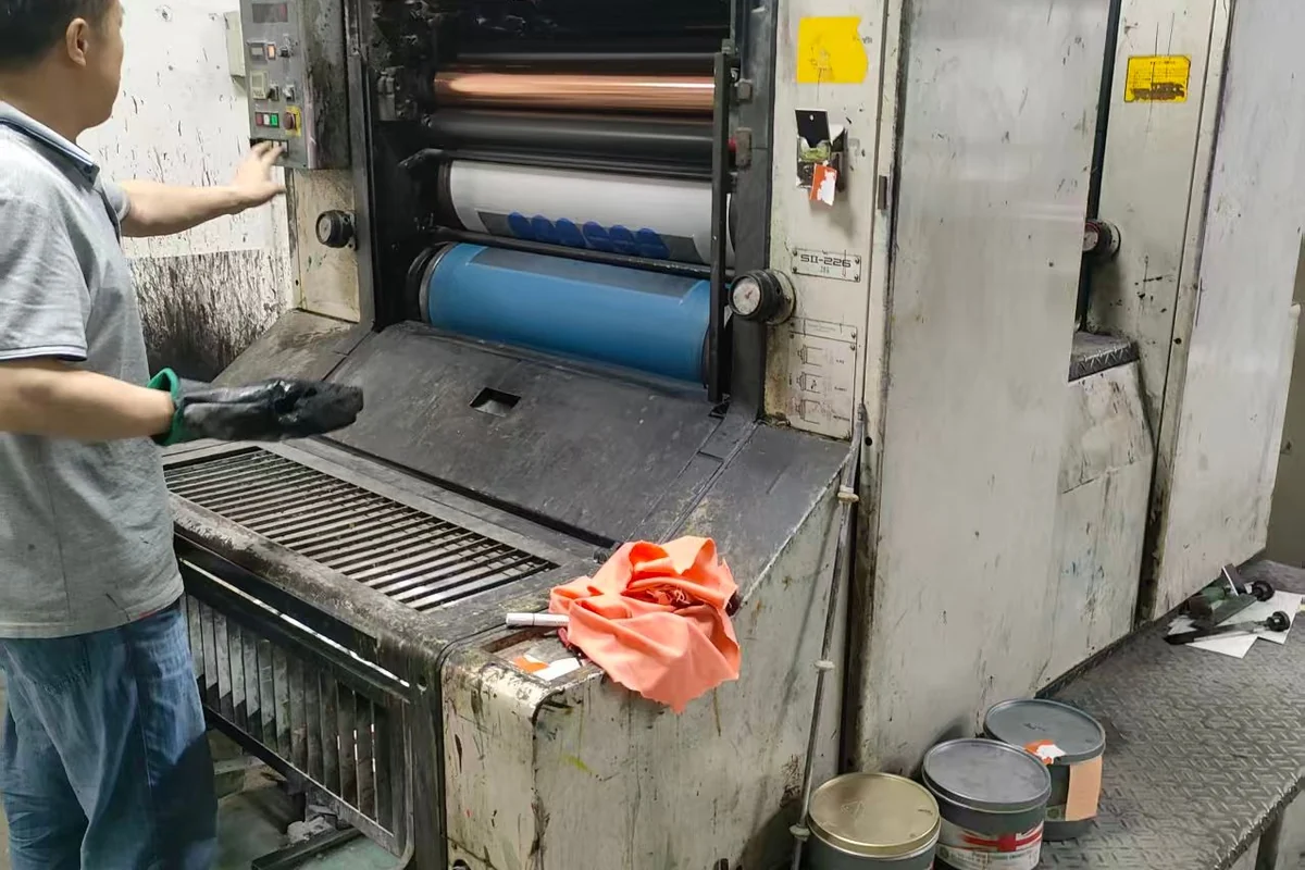 A printing press and its sheet-feeding area.