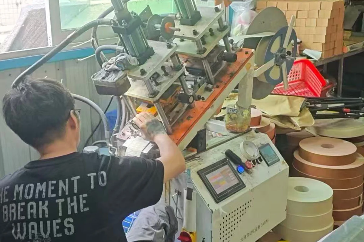 An operator working at a surface-finishing press.