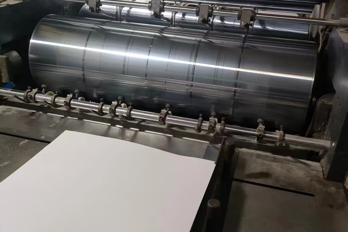 Paper sheets and rollers at a printing press.