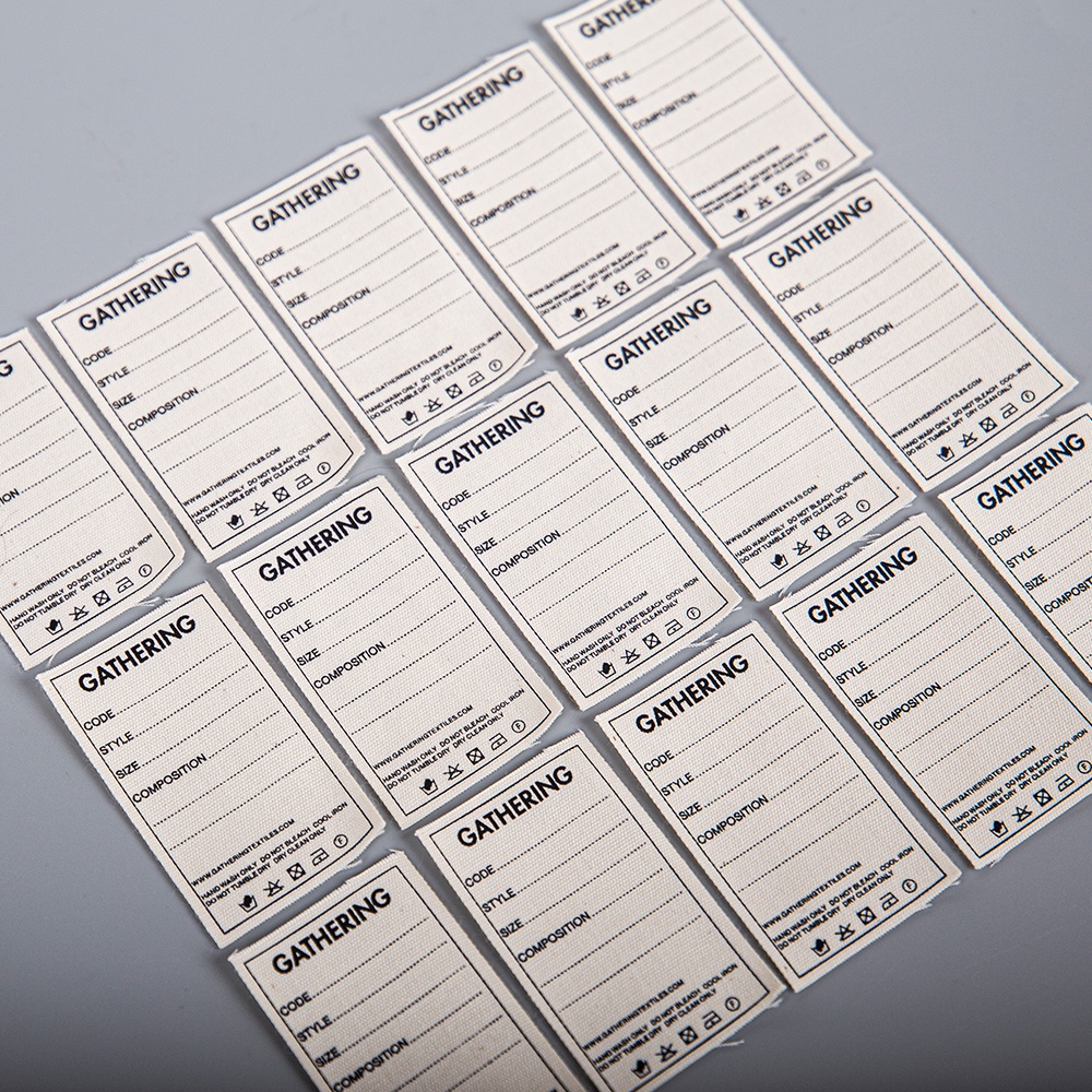 Cream fabric labels printed with separate fields and care instructions.