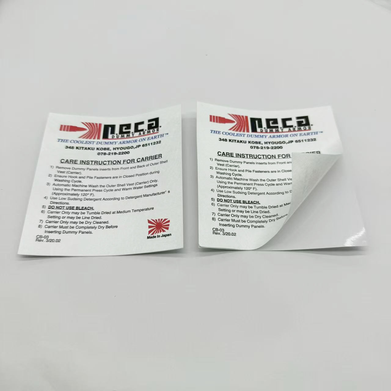 Two rectangular care-information stickers, with one corner lifted to show the release backing.