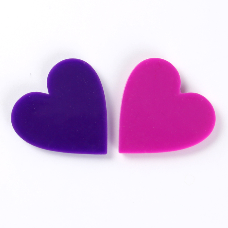 The plain backs of purple and pink heart-shaped label samples.