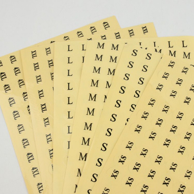 Sheets of letter-size stickers with black markings on yellow release backing.