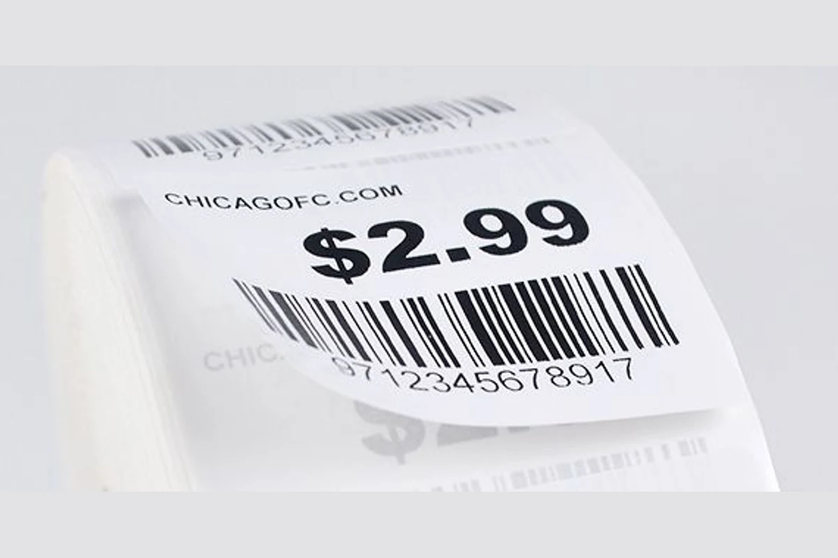 Close-up of a white price label with a lifted edge and printed barcode.