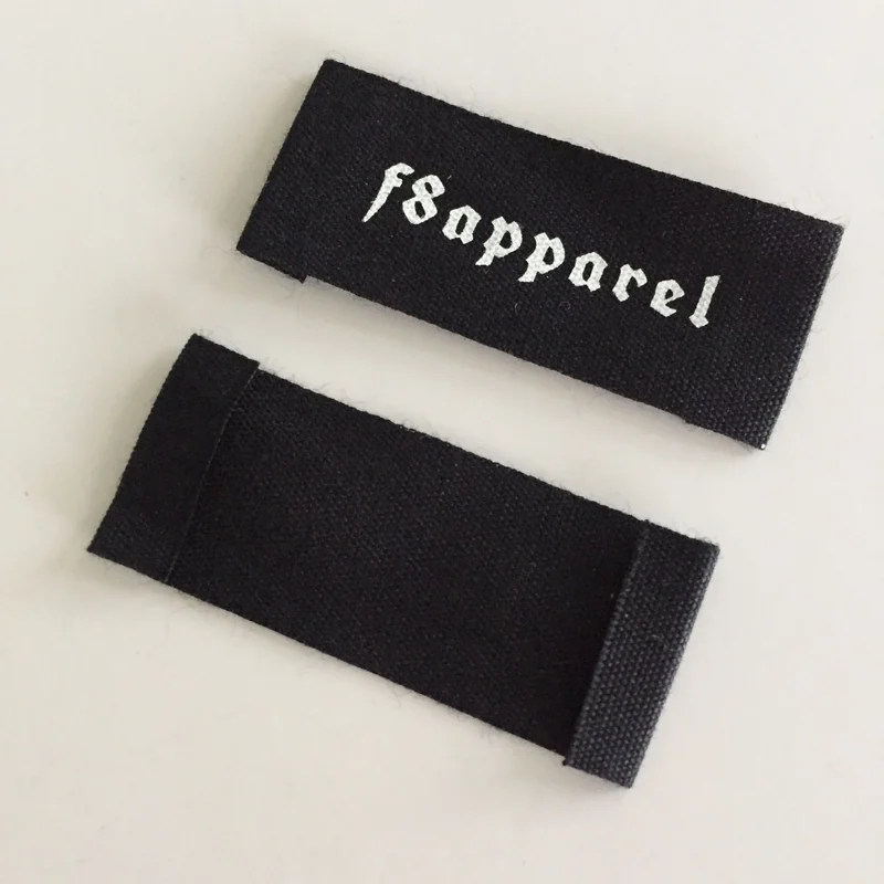 Black brand label with folded ends and white lettering.