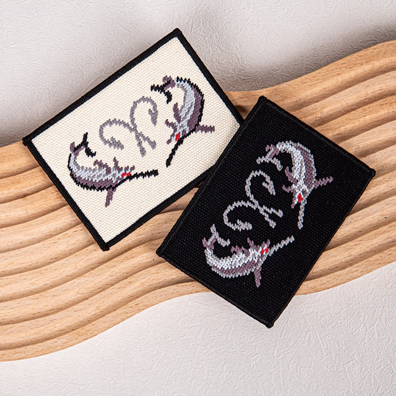 Black and cream brand labels with a colorful woven motif.