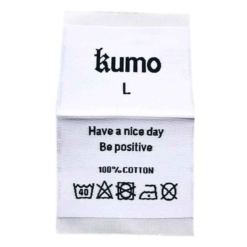 A white folded label with a brand name and washing symbols.