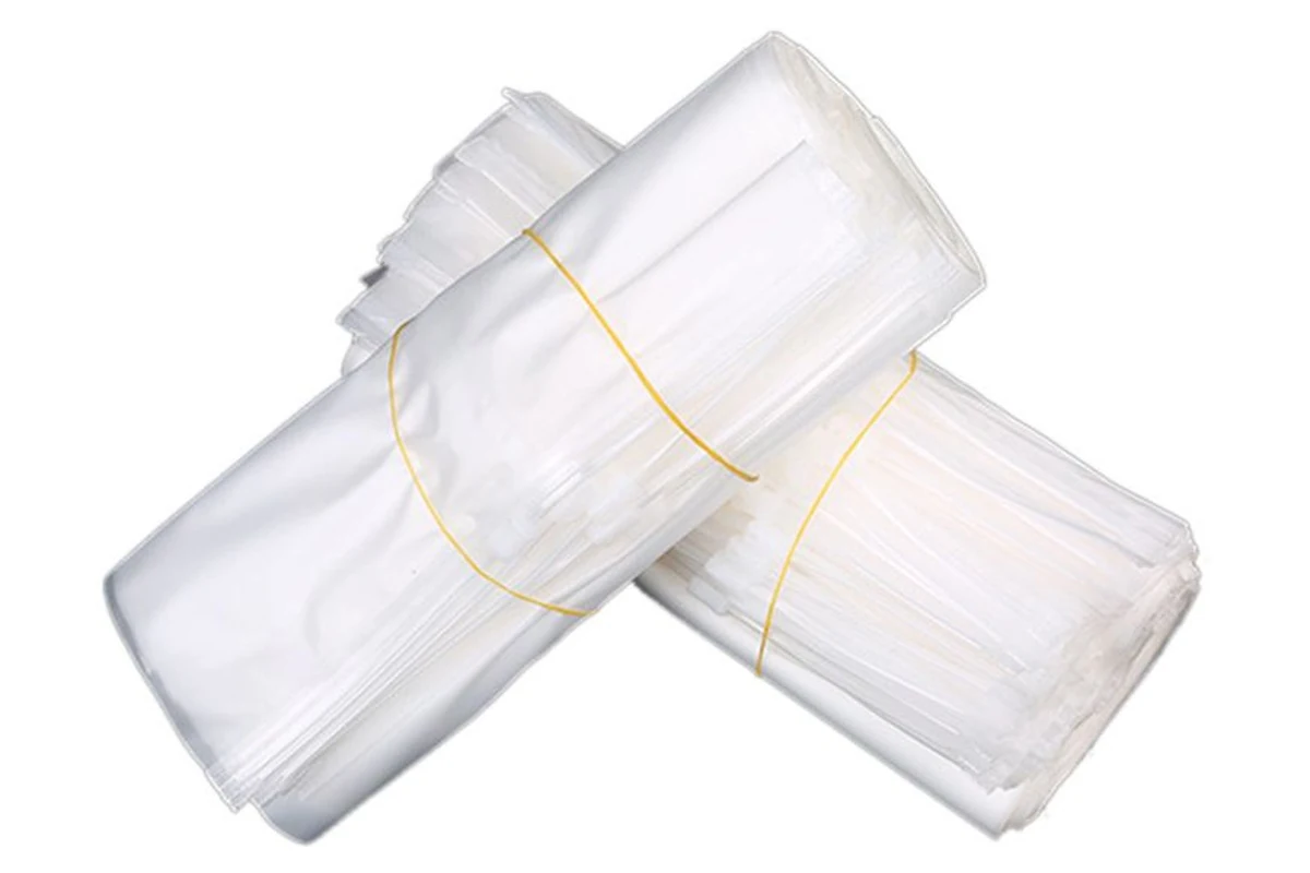 Bundles of clear packaging bags secured with yellow bands.