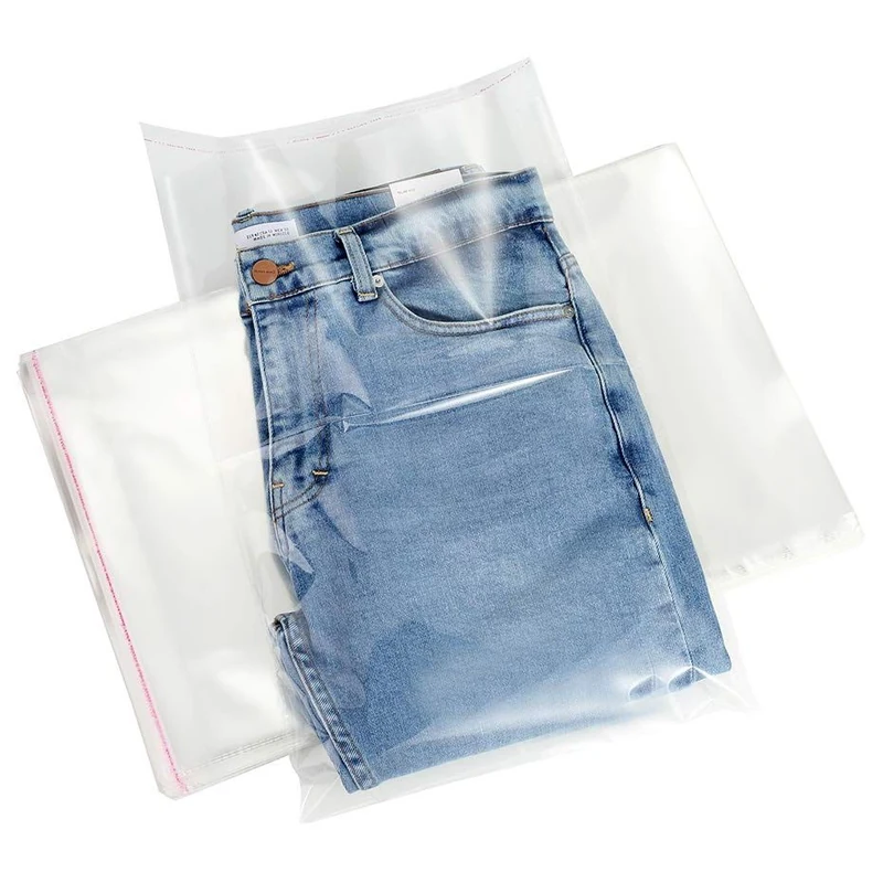Folded jeans inside a clear self-seal garment bag.