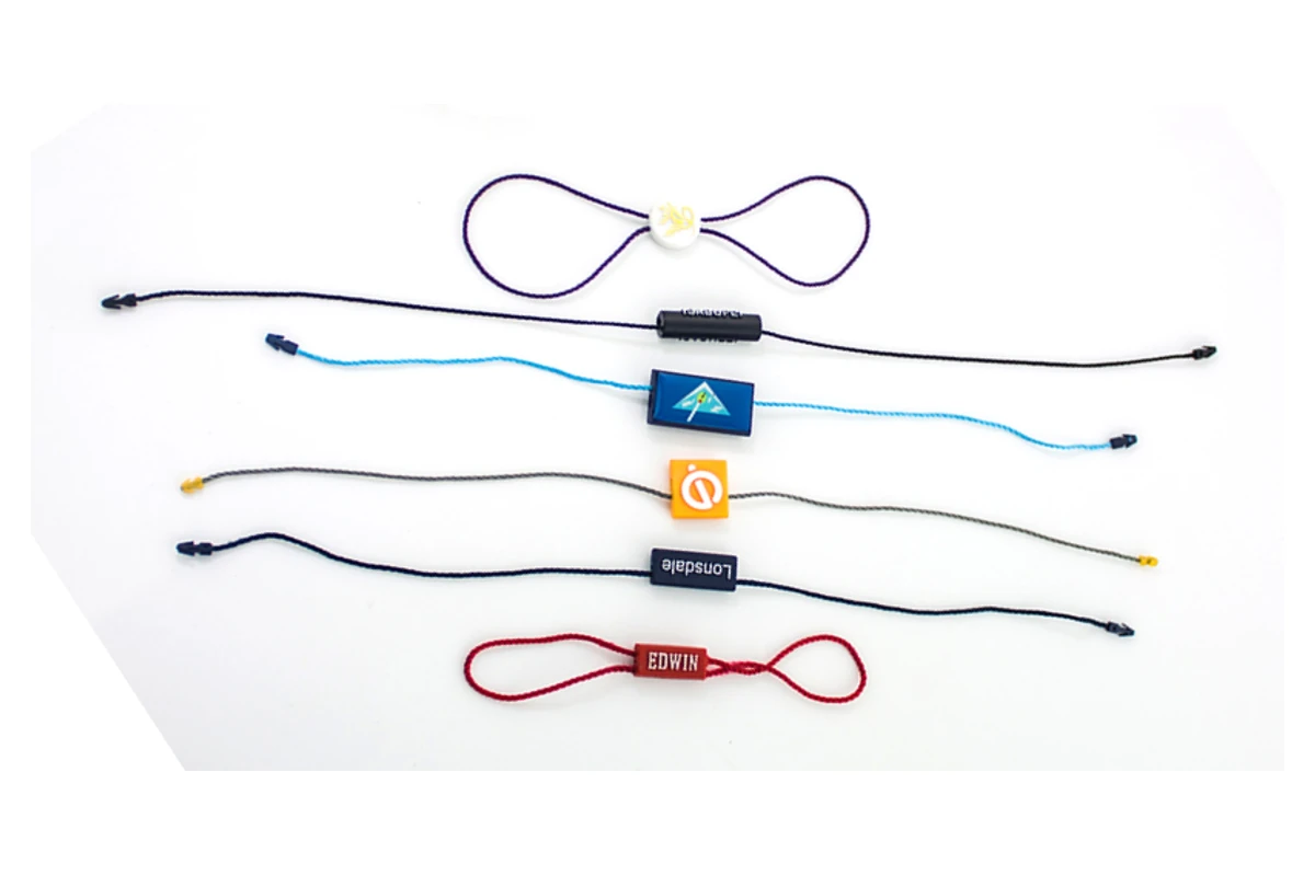 Colored tag cords and loops with contrasting logo locking pieces.