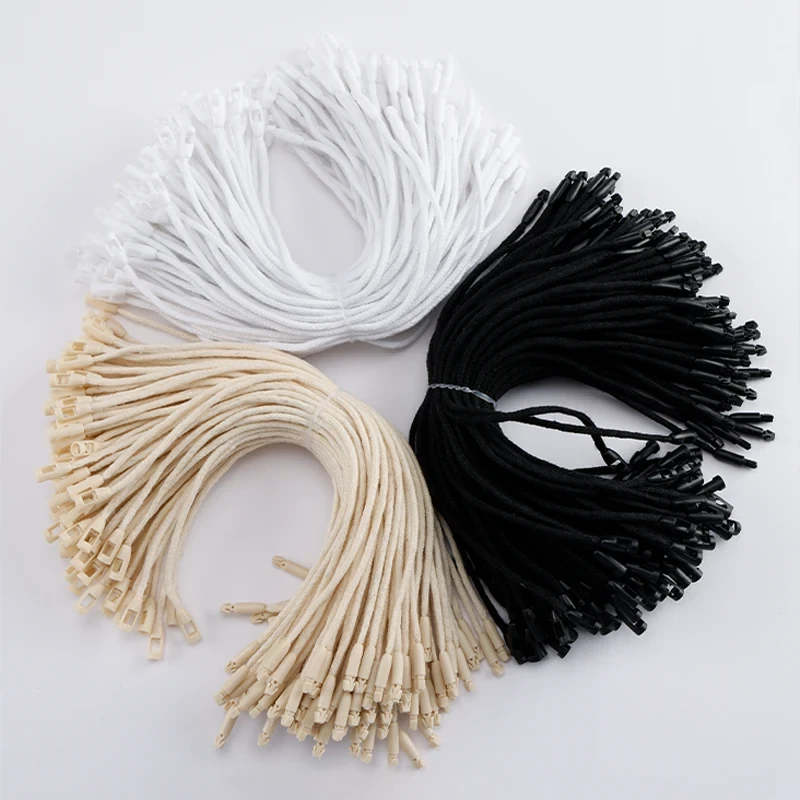 Bundles of white, beige and black tag cords.