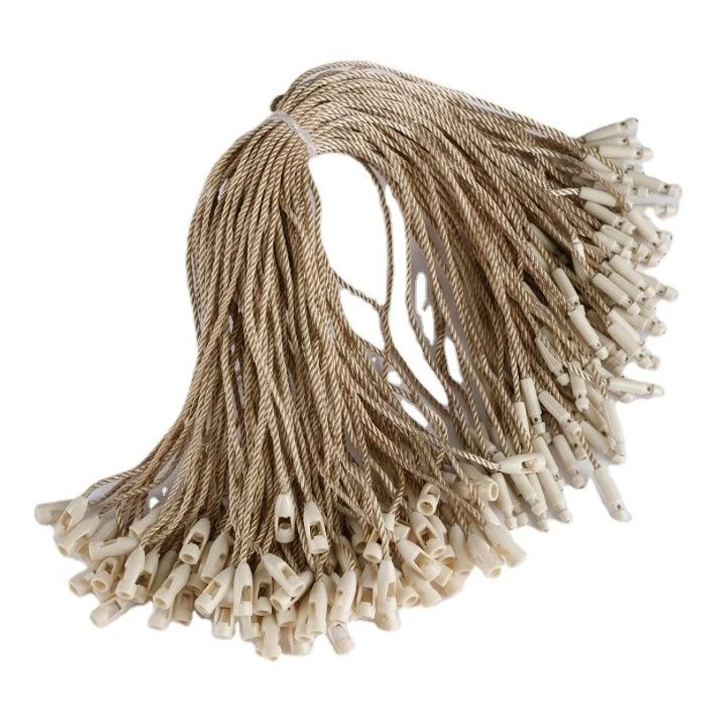 A bundle of beige tag cords with plastic locking ends.