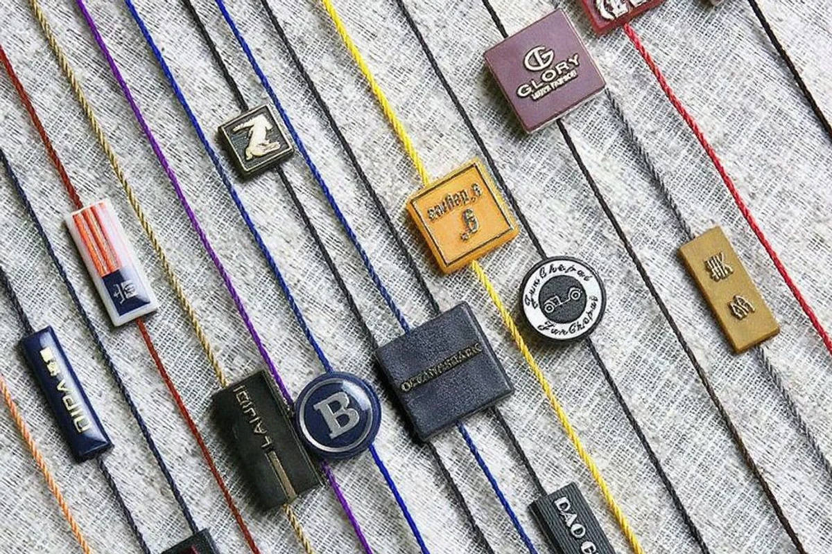 Close-up of colored tag cords and assorted logo locking pieces.
