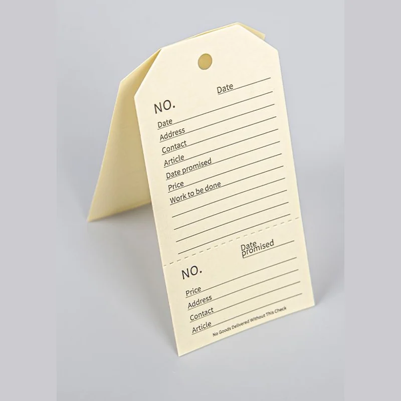 An open folded cream tag with printed information.