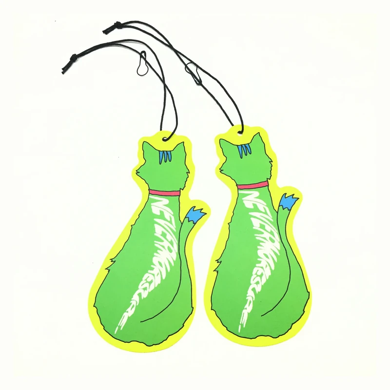 Two green hang tags cut into decorative shapes.