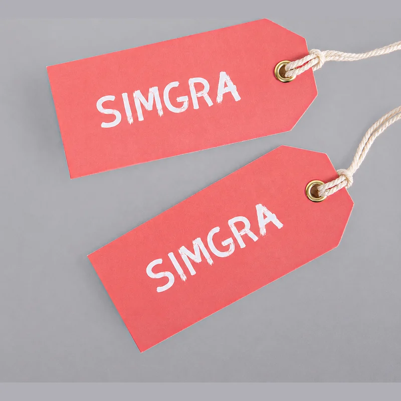 Two pink single-card hang tags with cord attachments.