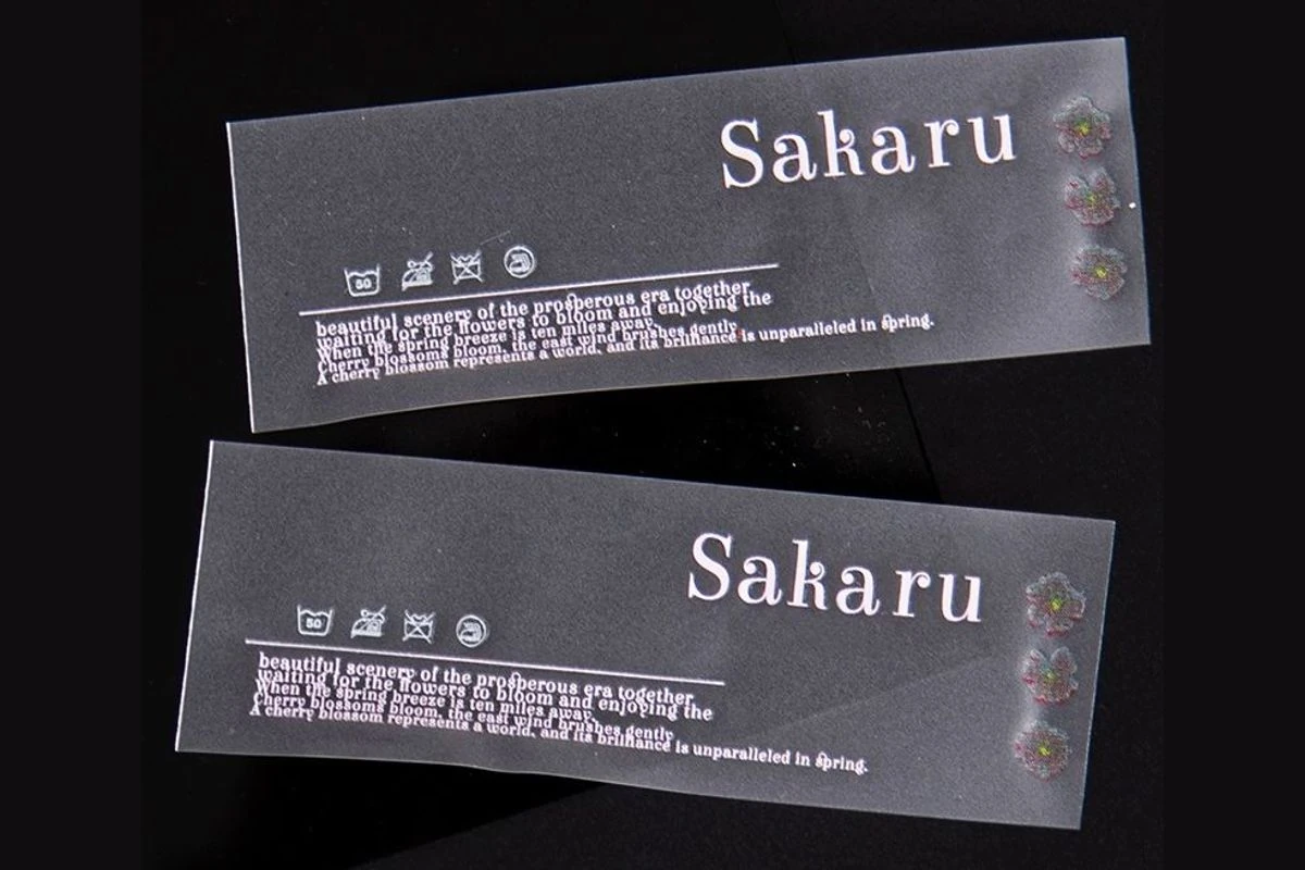 Logo and care-information transfers on clear backing sheets.