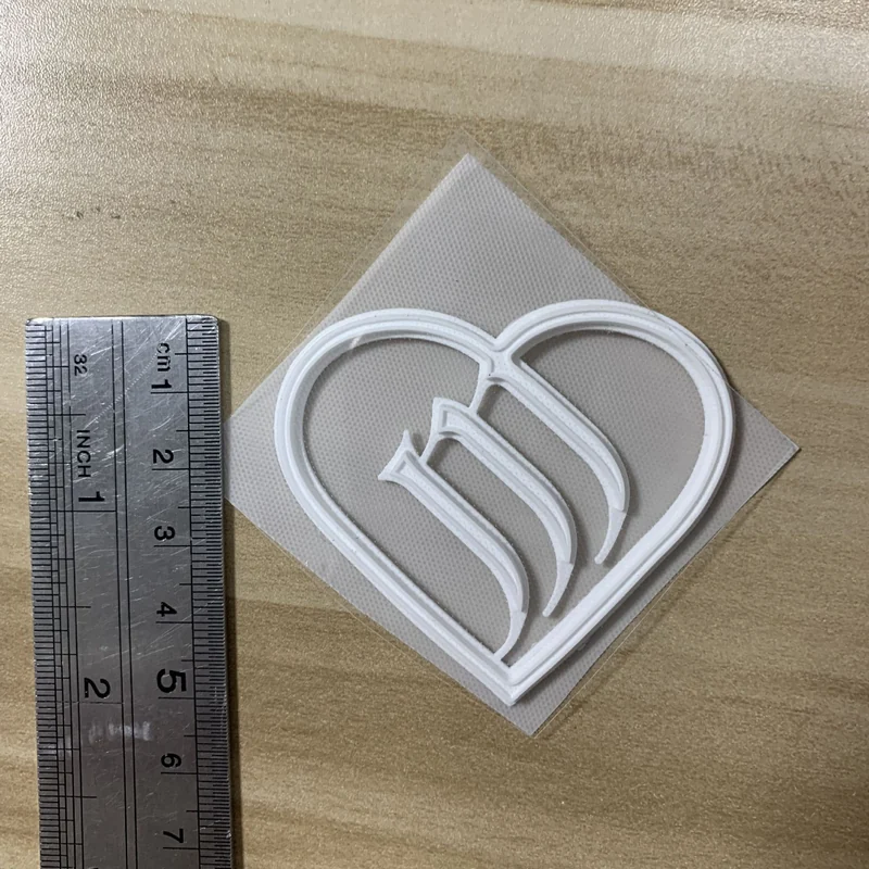 White raised logo transfer with rounded edges.