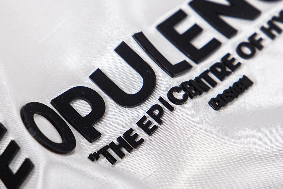Black heat-transfer lettering on white fabric.