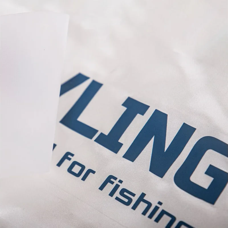 Blue transfer lettering on white fabric.