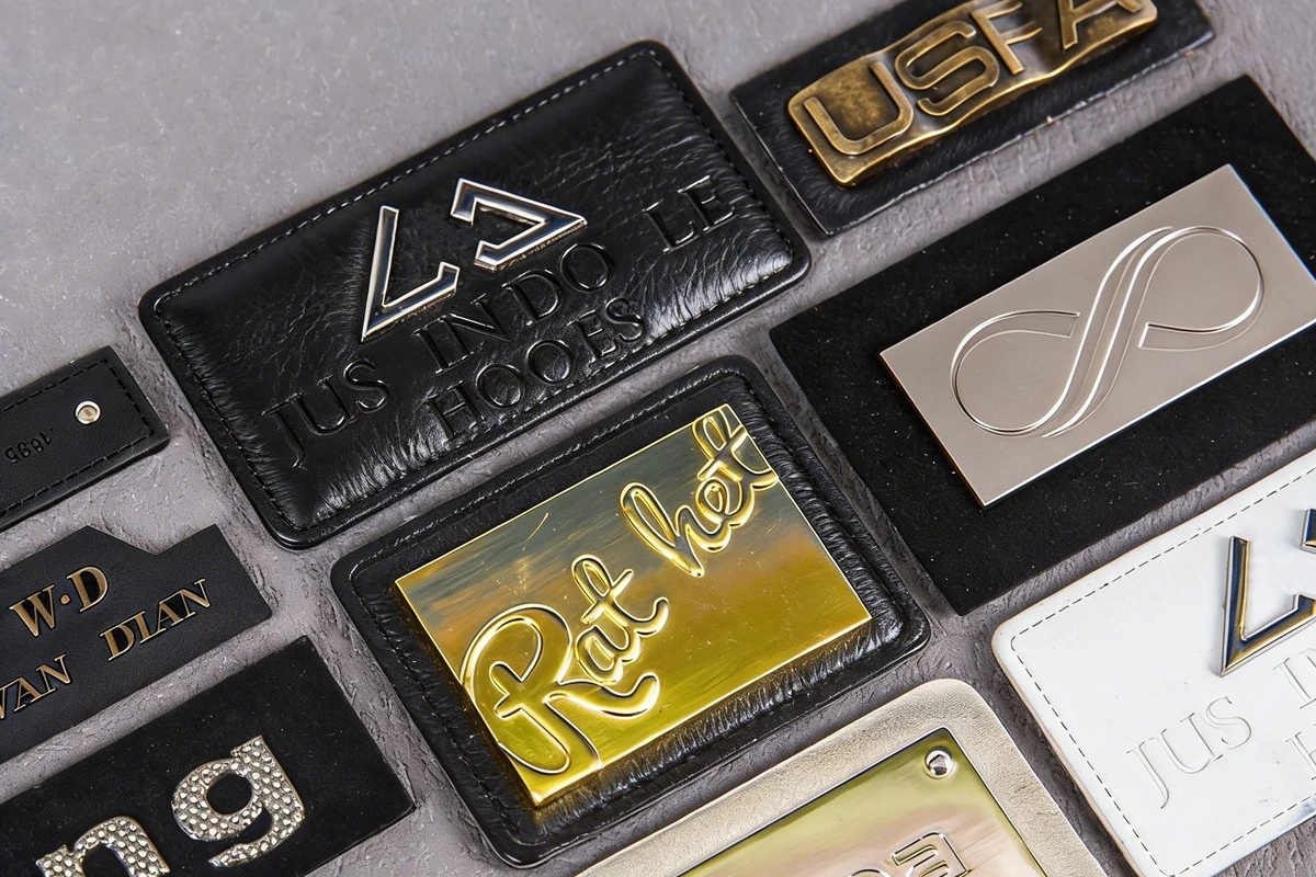 Close-up of leather labels with contrasting logo colors and raised details.