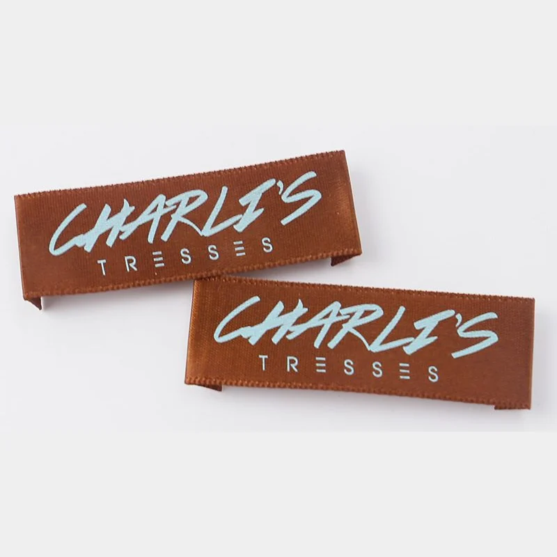Brown satin labels with white printed lettering.