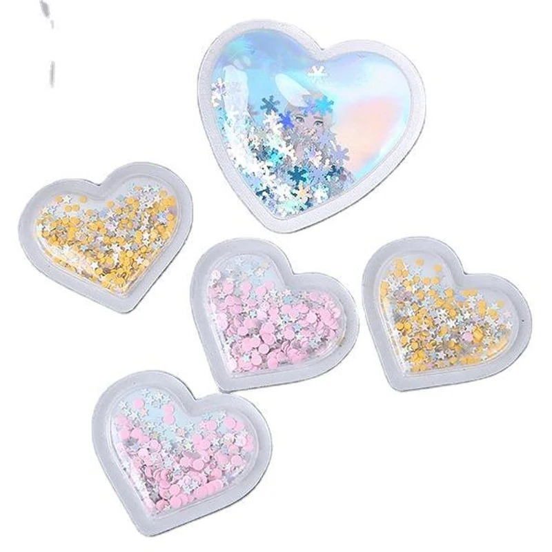 Clear heart-shaped PVC pieces containing pastel glitter.