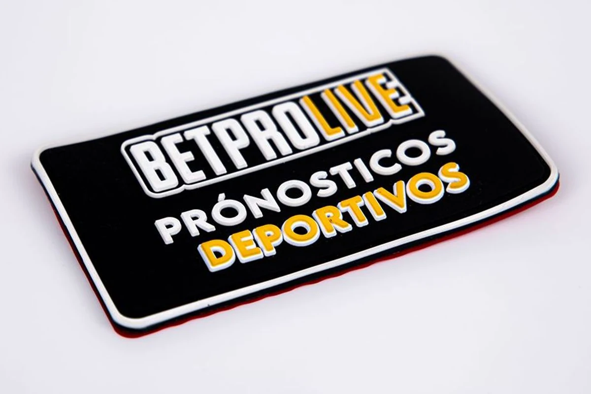 A black rectangular molded label with raised white and yellow lettering.