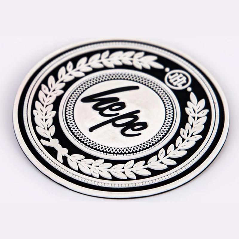 A round black and white molded label with a decorative border.