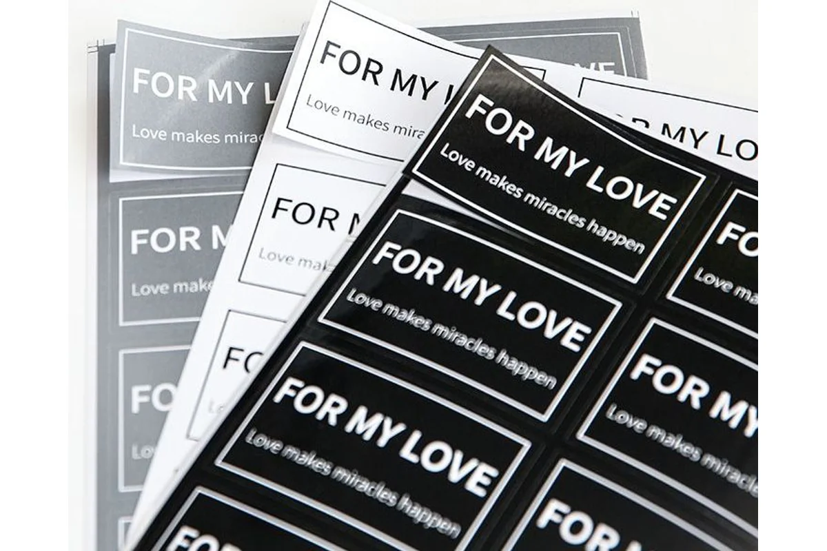 Black and white rectangular logo-sticker sheets.