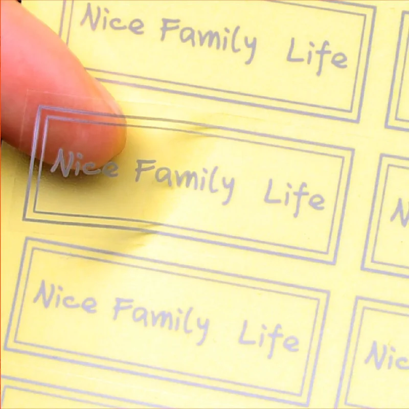 Rectangular transparent stickers with gold borders and Nice Family Life lettering.