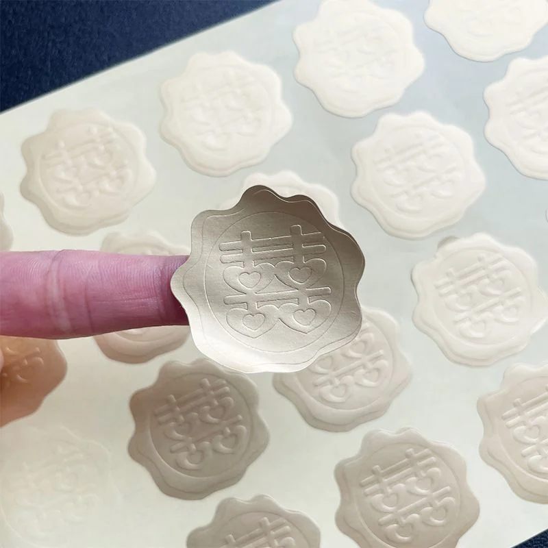 Cream-colored scalloped stickers with raised double-happiness symbols.