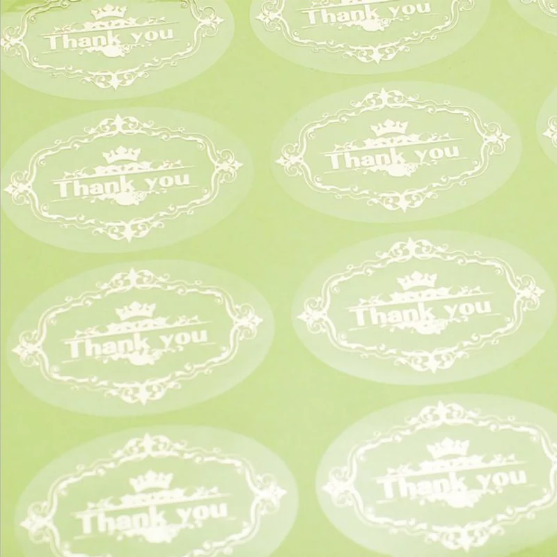 Transparent round Thank you stickers supplied on a green backing sheet.