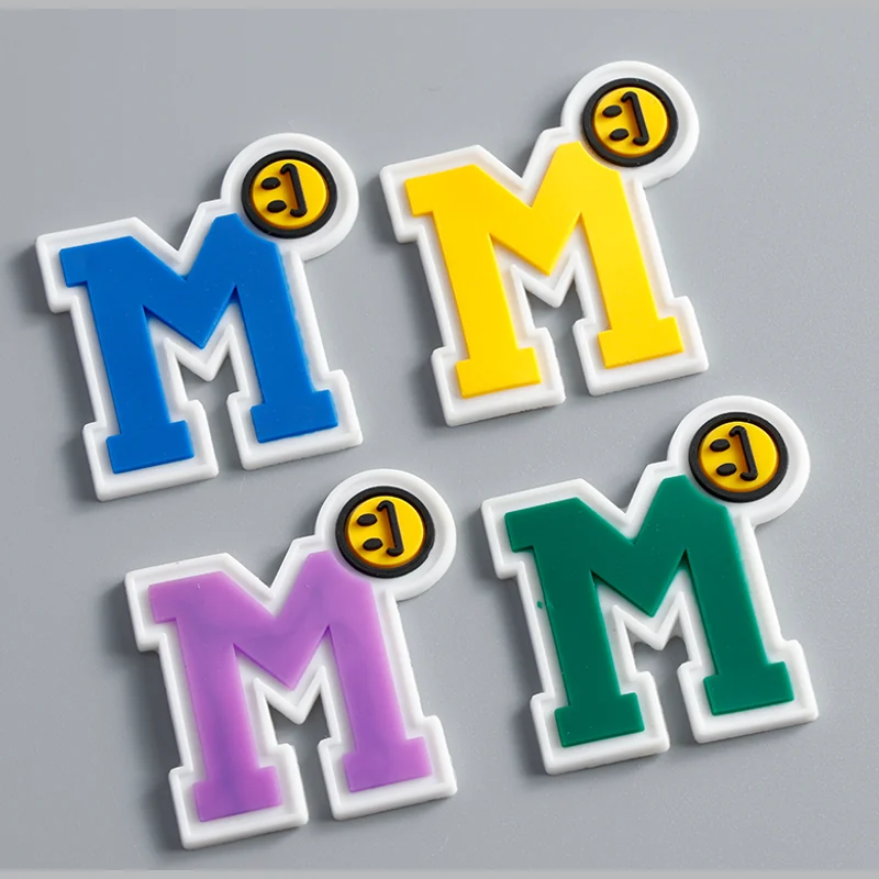 Four molded letter labels in blue, yellow, purple and green.