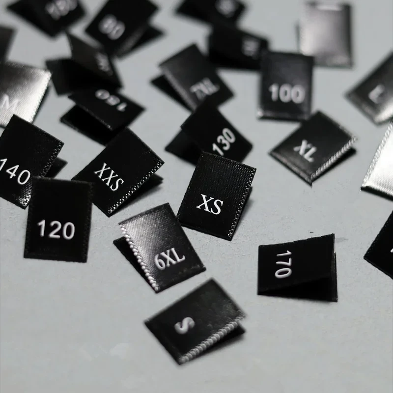 Finished black size labels with clear white markings.