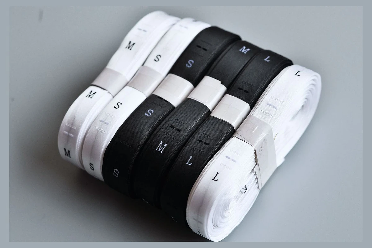 Black and white size label tape on rolls.