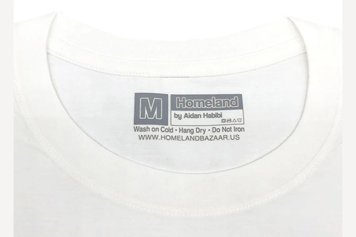 A transfer size marking inside the neckline of a white garment.