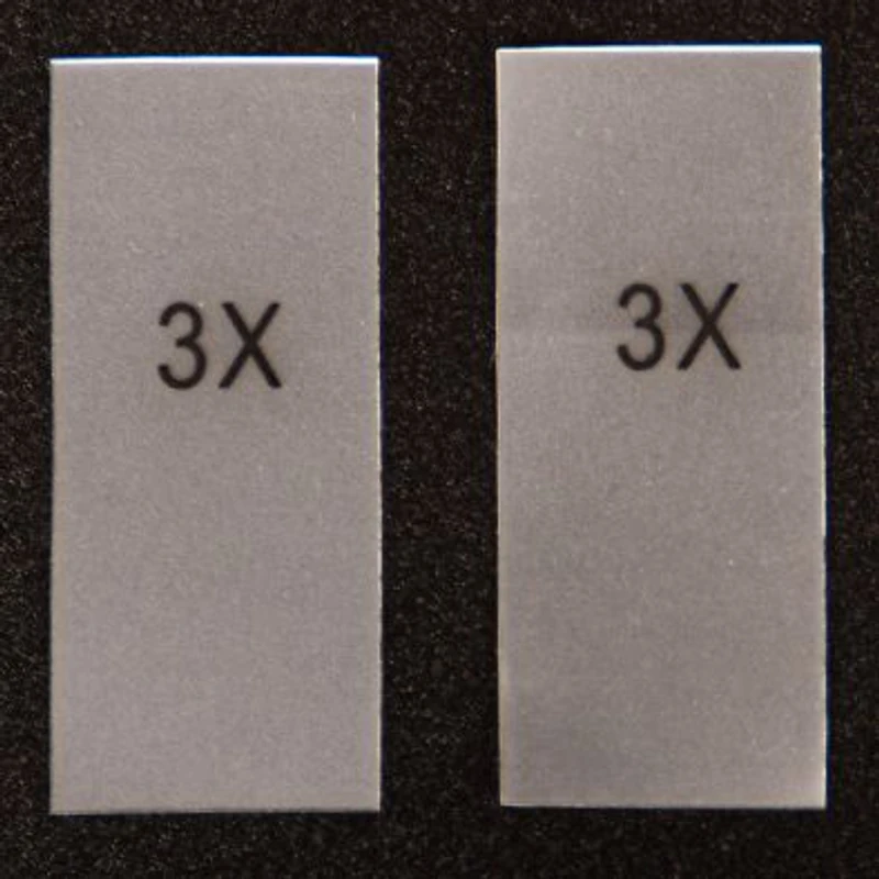 Two rectangular transparent stickers with printed size markings.