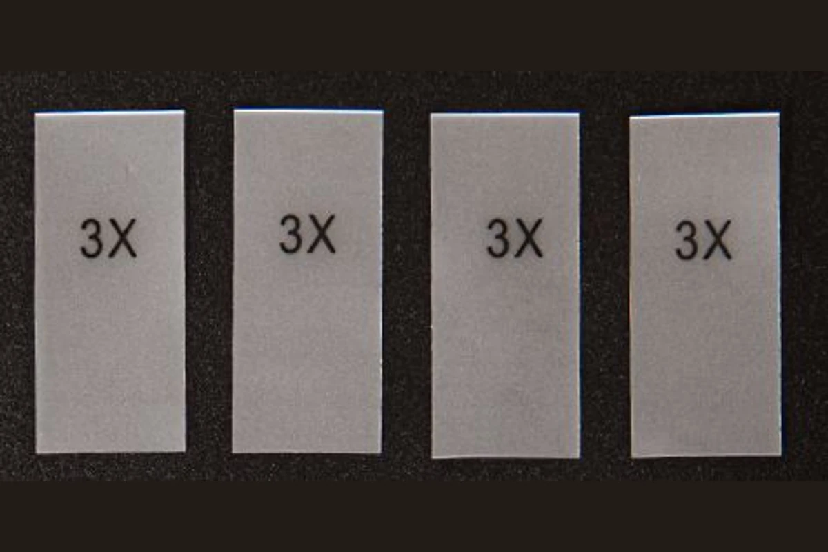 Transparent rectangular size stickers with printed letter markings.