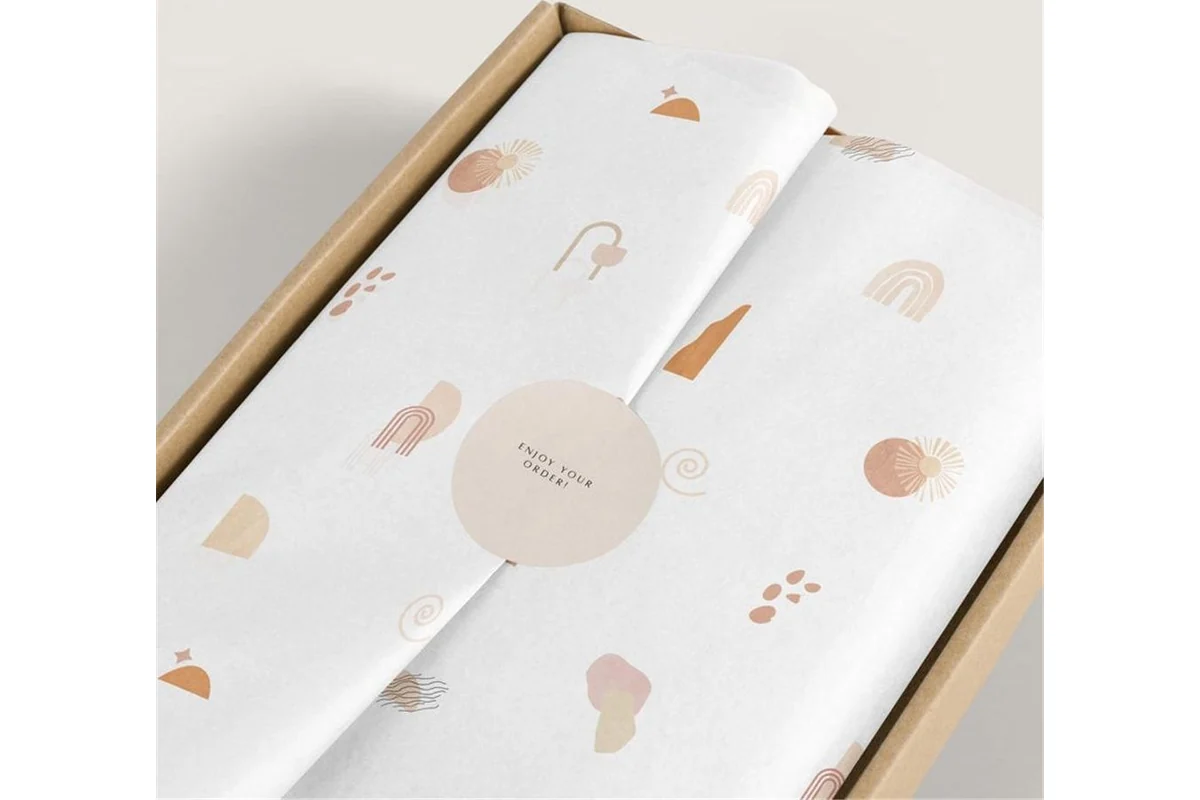 Printed wrapping paper folded around a box to show the sheet layout.