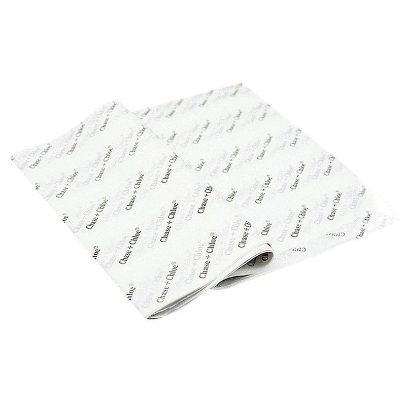 White wrapping-paper sheets with a repeating dark logo print.