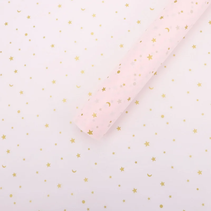 Pale pink wrapping paper with small gold-colored stars.