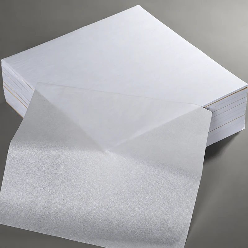 White tissue-paper sheets with a draped sample showing their thin texture.