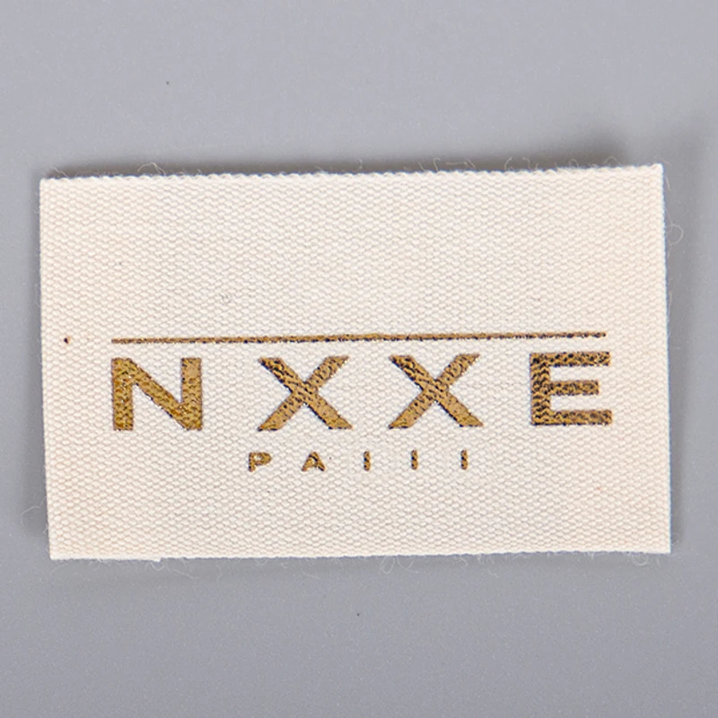Cream woven label with a neat fabric edge.