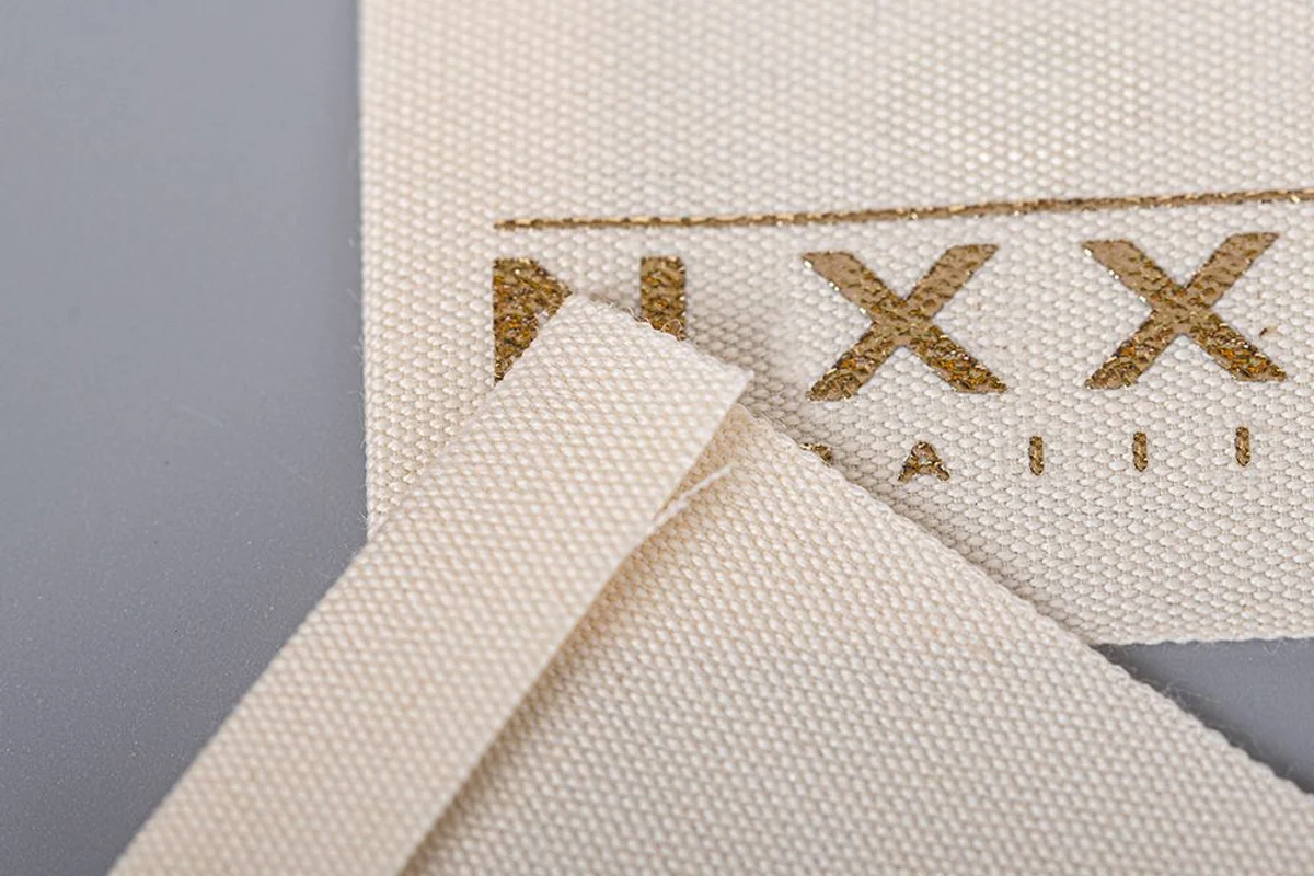 Cream woven labels showing the fabric texture.