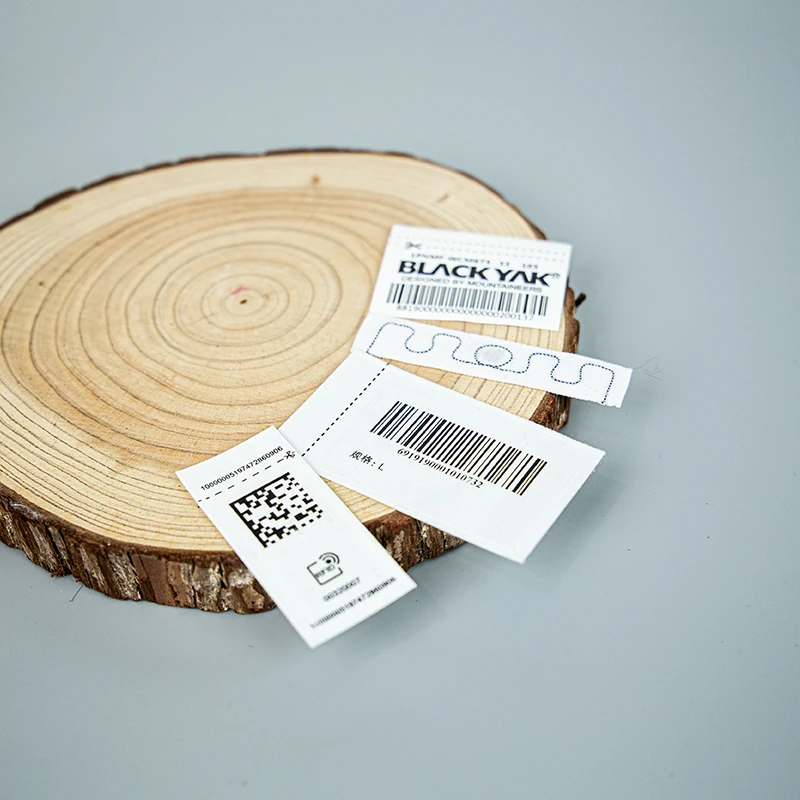 Barcode and two-dimensional code label samples on a wooden surface.