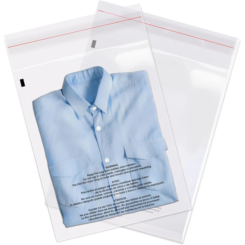 Clear self-sealing garment bags, including one holding a folded blue shirt with printed warning text.