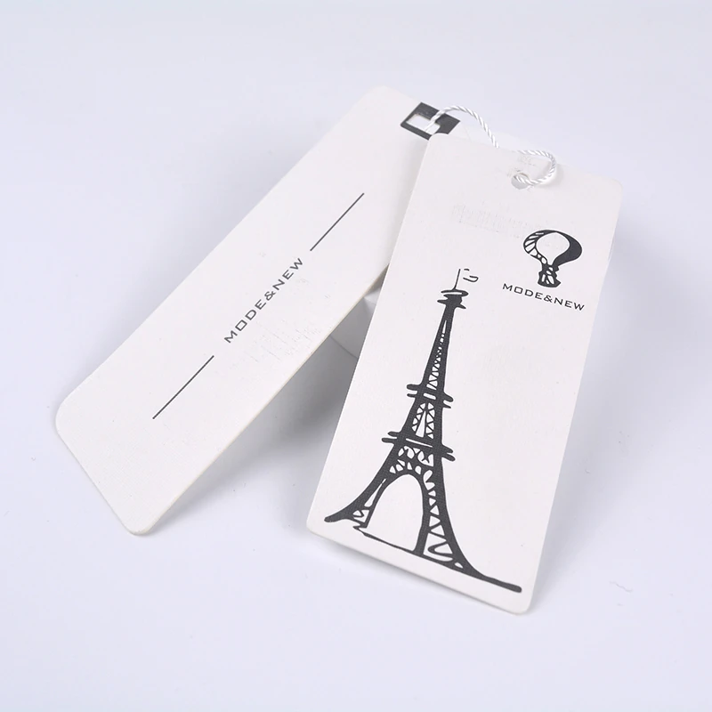 Two white paper hang tags with black printed designs and a cord.